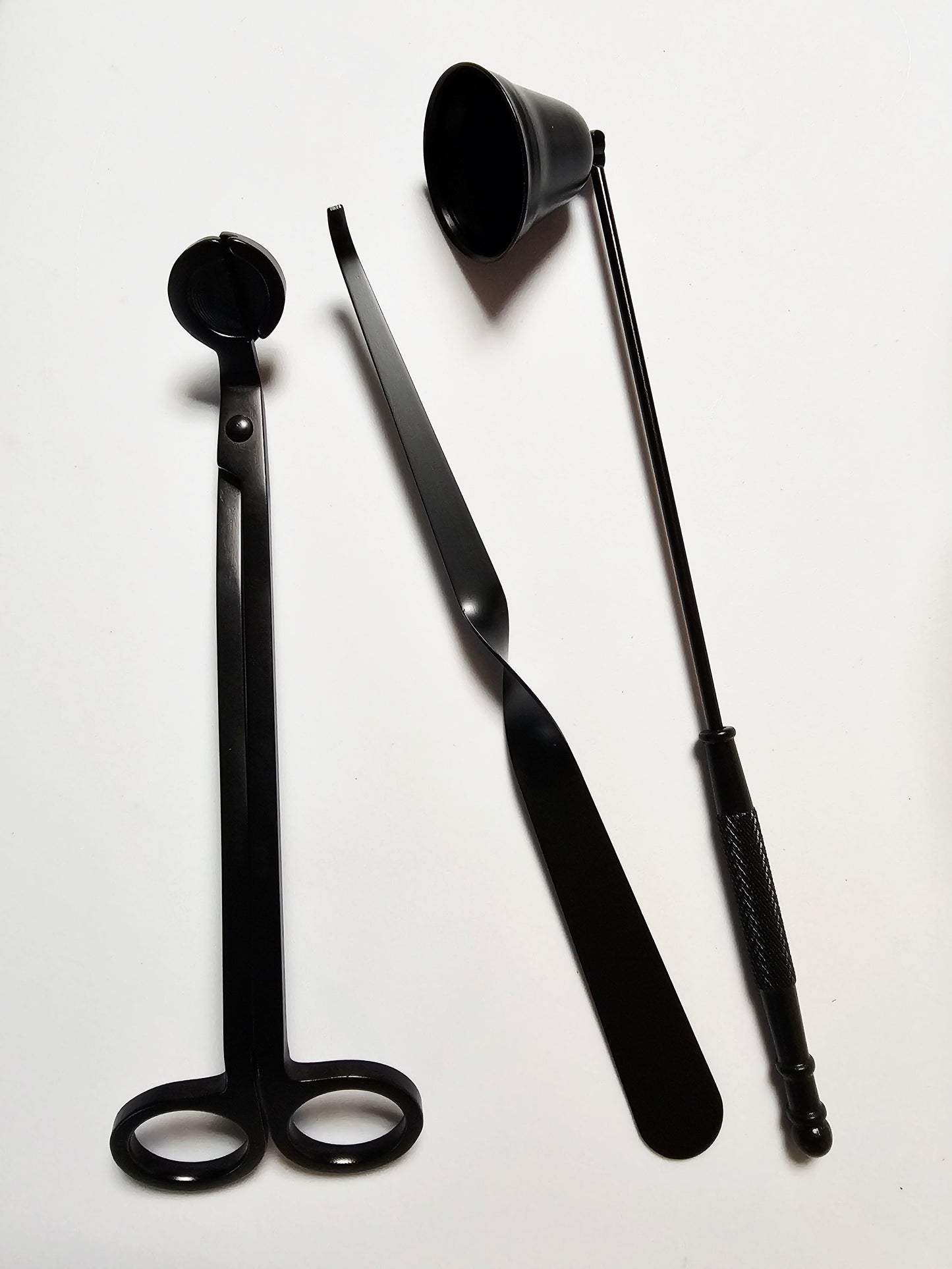 Three black metal tools on a white background