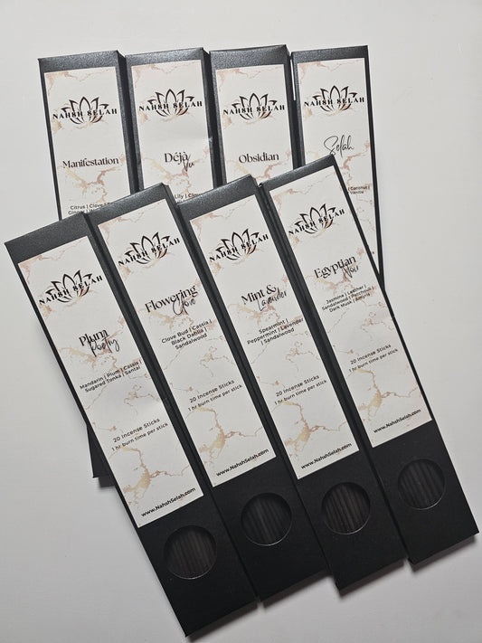 Boxes of incense sticks on a light gray background