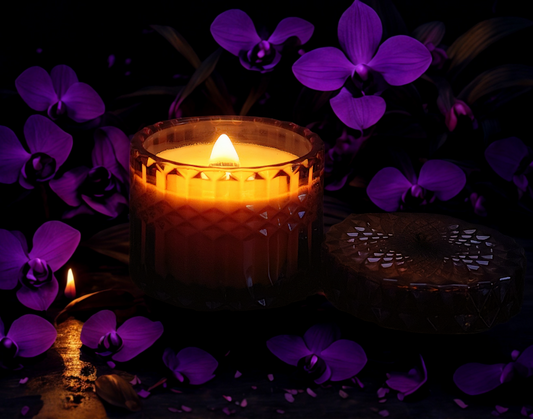 Candle with purple flowers in the dark